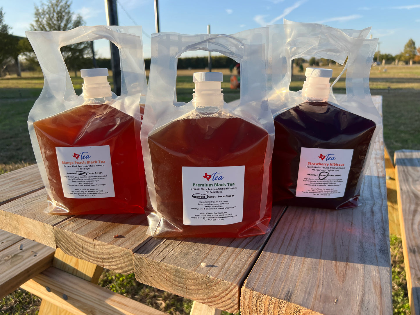 Picture of 3 gallon teas on wood table